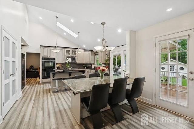 9 Valley Forge Dr, East Brunswick, NJ 08816 - kitchen with a spacious island, stainless steel microwave, a kitchen breakfast bar, french doors, and tasteful backsplash