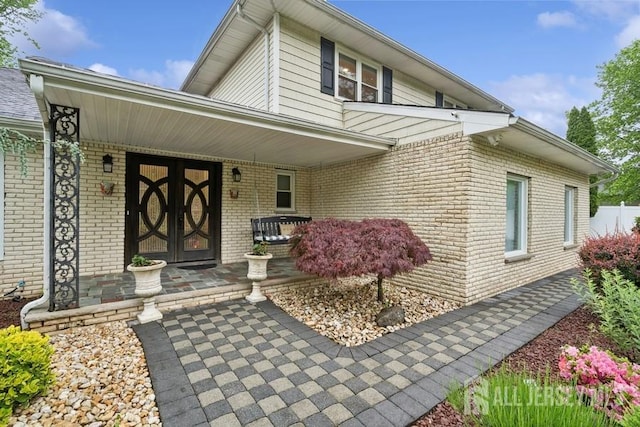 9 Valley Forge Dr, East Brunswick, NJ 08816 - entrance to property with covered porch and brick siding