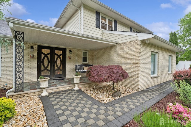9 Valley Forge Dr, East Brunswick, NJ 08816 - entrance to property featuring covered porch and brick siding