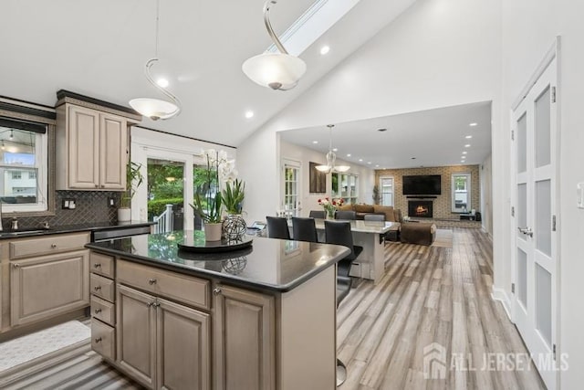 9 Valley Forge Dr, East Brunswick, NJ 08816 - kitchen with a center island, light wood-type flooring, open floor plan, backsplash, and recessed lighting