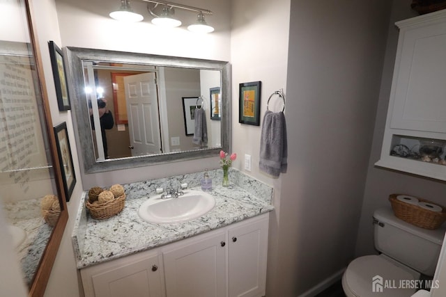 bathroom featuring vanity and toilet