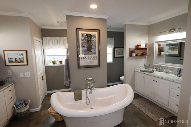 full bath with vanity, crown molding, a freestanding tub, and baseboards