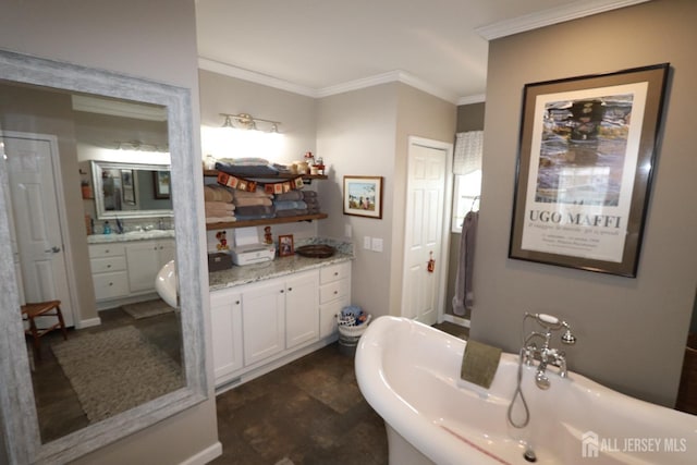 full bath featuring vanity, crown molding, and a soaking tub