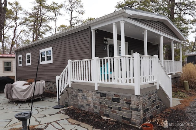 rear view of house with covered porch