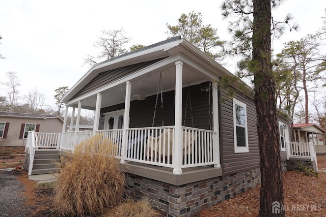 view of property exterior featuring crawl space and covered porch