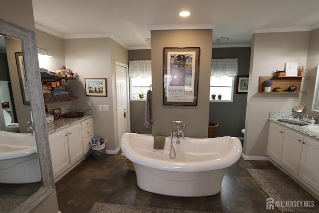 bathroom featuring a sink, a soaking tub, two vanities, and ornamental molding