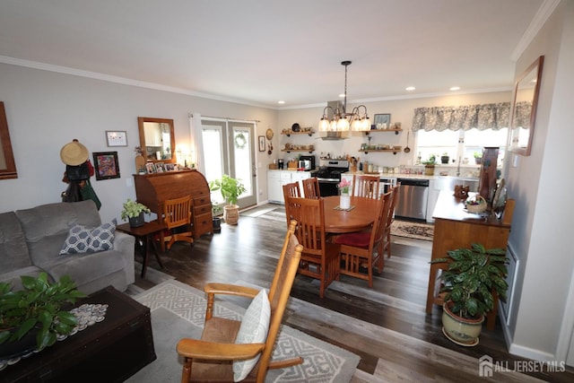 dining area with a wealth of natural light, dark wood-style floors, crown molding, and an inviting chandelier