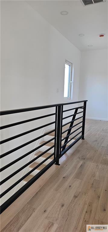 stairway featuring wood finished floors and baseboards