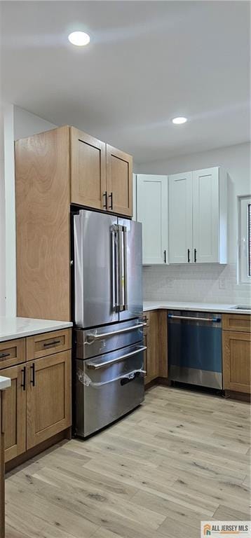 374 Oak St, Perth Amboy, NJ 08861 - kitchen featuring stainless steel appliances, light wood-style floors, light countertops, backsplash, and recessed lighting
