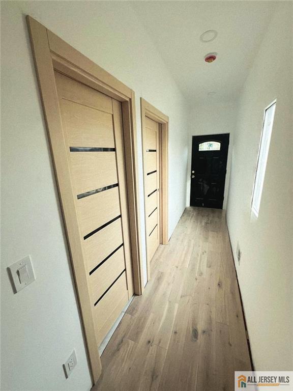 374 Oak St, Perth Amboy, NJ 08861 - corridor featuring light wood-type flooring