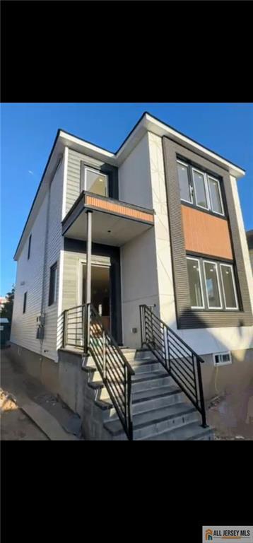 rear view of house featuring stairs