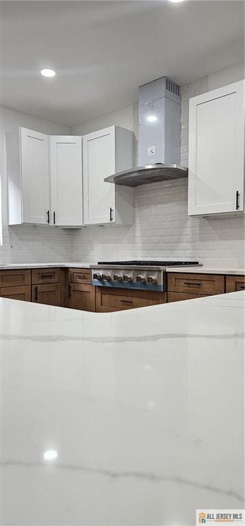 374 Oak St, Perth Amboy, NJ 08861 - kitchen featuring wall chimney exhaust hood, tasteful backsplash, light countertops, stainless steel gas stovetop, and recessed lighting