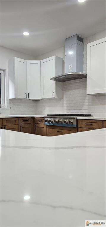 374 Oak St, Perth Amboy, NJ 08861 - kitchen featuring wall chimney range hood, decorative backsplash, and light countertops