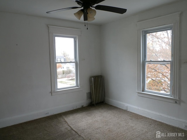 15 S 8th Ave S, Highland Park, NJ 08904 - unfurnished room featuring radiator, light colored carpet, ceiling fan, and baseboards