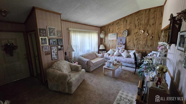 living room with carpet flooring, ornamental molding, a textured ceiling, vaulted ceiling, and wood walls