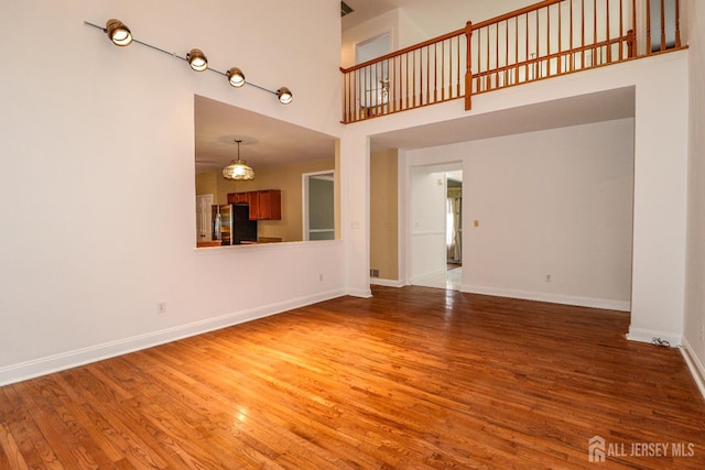 8 Staudt Ct, Franklin, NJ 08873 - unfurnished living room featuring a high ceiling and wood finished floors