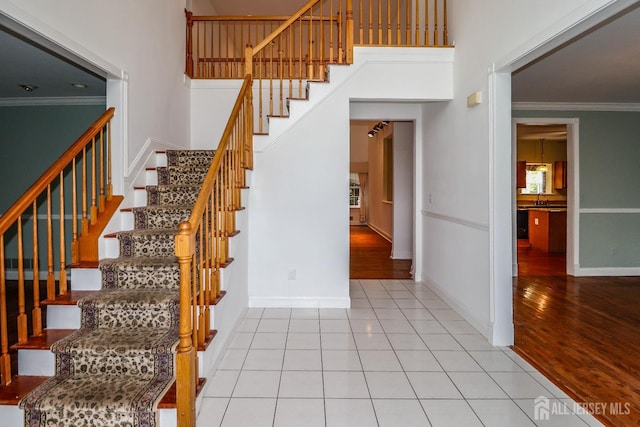8 Staudt Ct, Franklin, NJ 08873 - staircase with crown molding, a towering ceiling, and wood finished floors