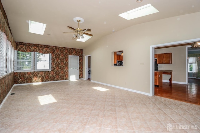 8 Staudt Ct, Franklin, NJ 08873 - spare room featuring a skylight, wallpapered walls, vaulted ceiling, ceiling fan, and washer / dryer