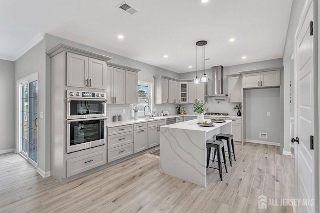 13 Markham Rd, Edison, NJ 08817 - kitchen featuring wall chimney range hood, appliances with stainless steel finishes, gray cabinets, a center island, and recessed lighting