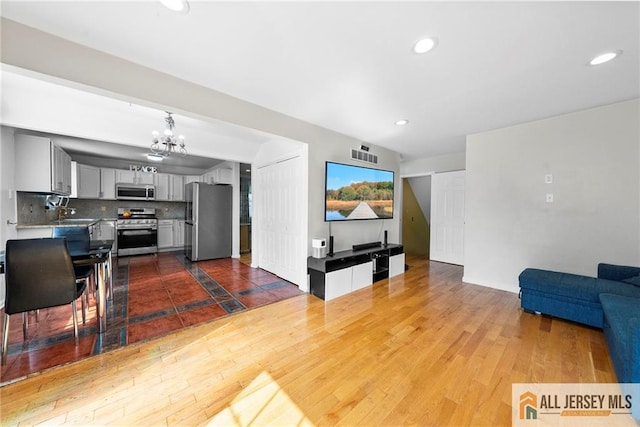 19 Edgegrove St, Edison, NJ 08837 - living area with a chandelier, dark wood-style flooring, and recessed lighting