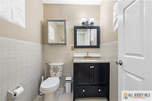 19 Edgegrove St, Edison, NJ 08837 - bathroom featuring tile walls, wainscoting, vanity, and tile patterned floors