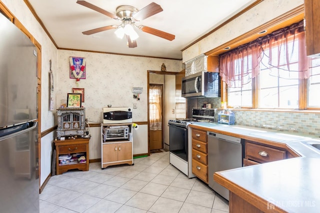 157 Orange St, Edison, NJ 08817 - kitchen with stainless steel appliances, light countertops, crown molding, ceiling fan, and light tile patterned floors