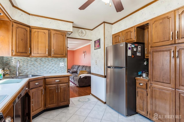 157 Orange St, Edison, NJ 08817 - kitchen with freestanding refrigerator, a ceiling fan, ornamental molding, a sink, and brown cabinets