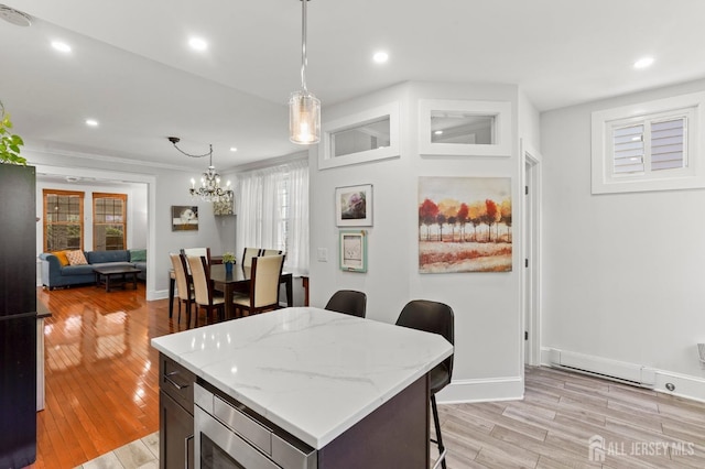 307 S 4th Ave, Highland Park, NJ 08904 - kitchen with a breakfast bar, plenty of natural light, light wood finished floors, and recessed lighting