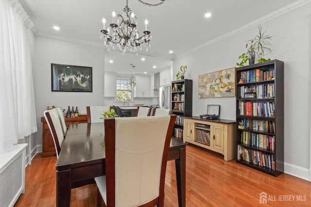 307 S 4th Ave, Highland Park, NJ 08904 - dining space with wood-type flooring, radiator heating unit, a chandelier, ornamental molding, and recessed lighting