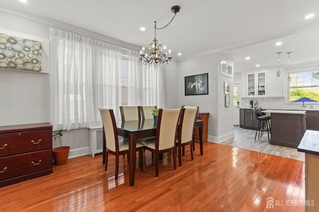 307 S 4th Ave, Highland Park, NJ 08904 - dining area with a chandelier, baseboards, light wood finished floors, recessed lighting, and crown molding