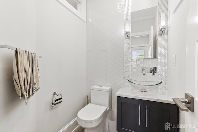 307 S 4th Ave, Highland Park, NJ 08904 - bathroom featuring toilet, backsplash, and vanity