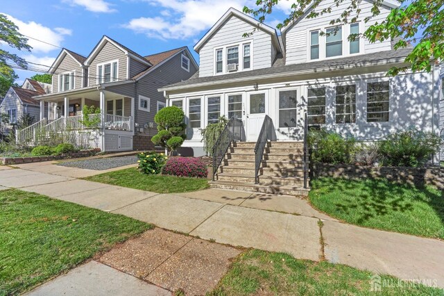307 S 4th Ave, Highland Park, NJ 08904 - view of front of house with a front yard and covered porch