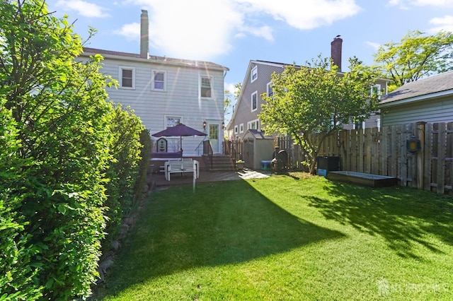 307 S 4th Ave, Highland Park, NJ 08904 - rear view of property featuring a storage unit, an outbuilding, a wooden deck, and a chimney
