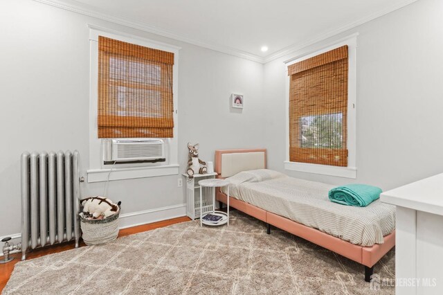 307 S 4th Ave, Highland Park, NJ 08904 - bedroom with radiator, cooling unit, ornamental molding, wood finished floors, and baseboards