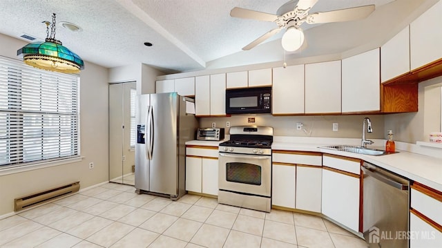 234 Wycoff Way E, Brunswick, NJ 08816 - kitchen featuring appliances with stainless steel finishes, a sink, baseboard heating, light countertops, and white cabinetry