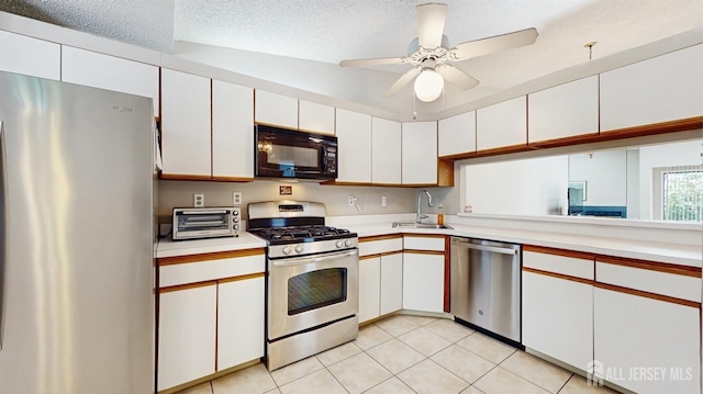 234 Wycoff Way E, Brunswick, NJ 08816 - kitchen with appliances with stainless steel finishes, a sink, light countertops, white cabinets, and light tile patterned flooring