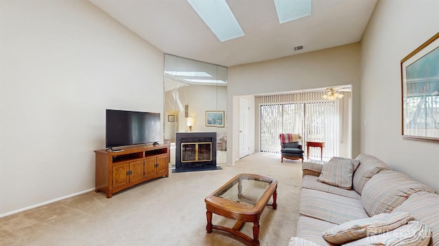 234 Wycoff Way E, Brunswick, NJ 08816 - living area featuring light colored carpet, a fireplace with flush hearth, high vaulted ceiling, a skylight, and baseboards