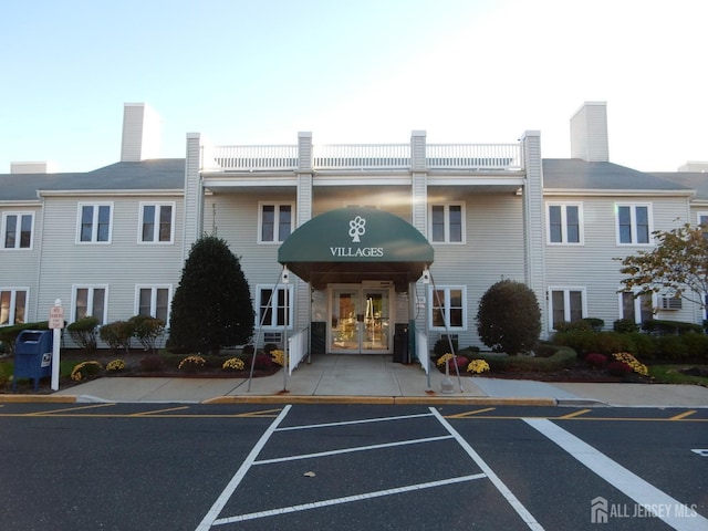 view of property featuring uncovered parking