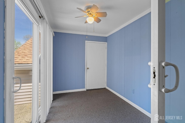 unfurnished bedroom featuring crown molding, baseboards, and ceiling fan