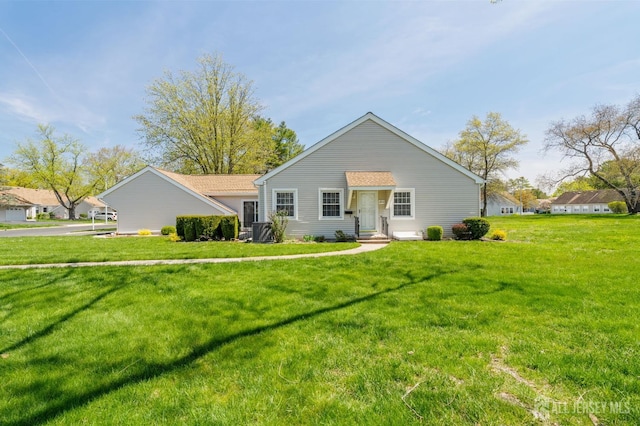 view of front of house with central AC and a front yard