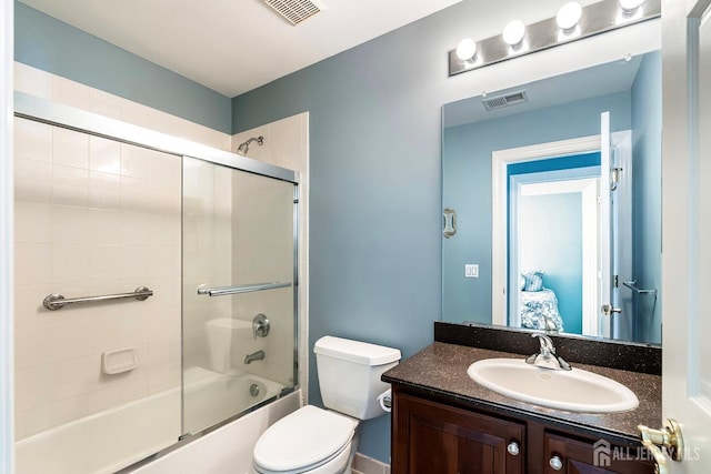 bathroom with toilet, visible vents, combined bath / shower with glass door, and vanity