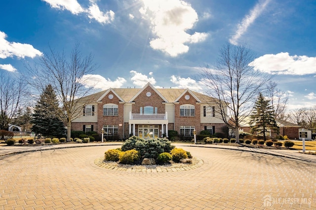 colonial house featuring brick siding