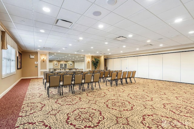 carpeted dining area with baseboards, visible vents, and crown molding