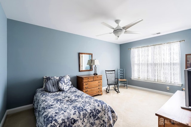 carpeted bedroom featuring visible vents, ceiling fan, and baseboards