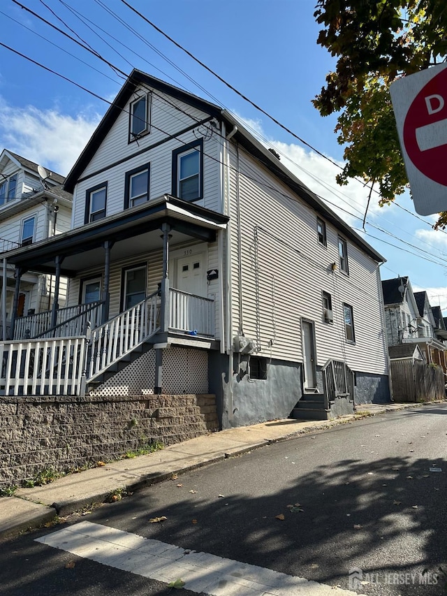 view of side of property with a porch