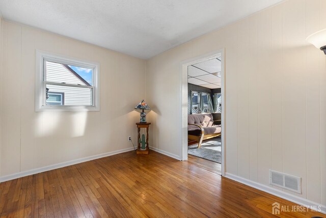 unfurnished room featuring wood-type flooring