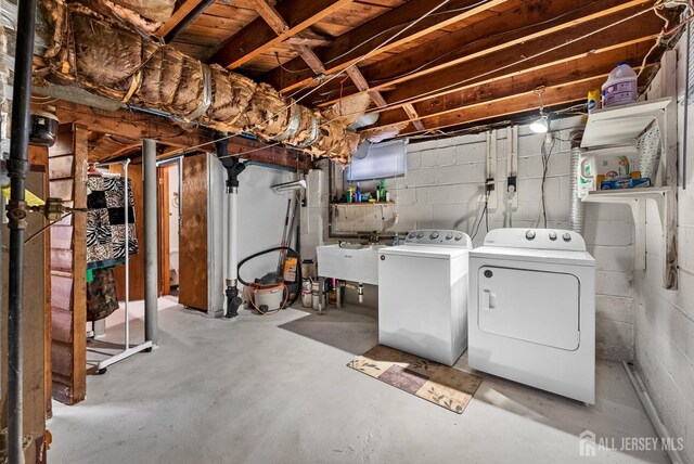 basement with separate washer and dryer and sink