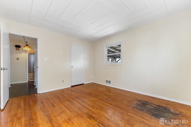 unfurnished room with hardwood / wood-style flooring