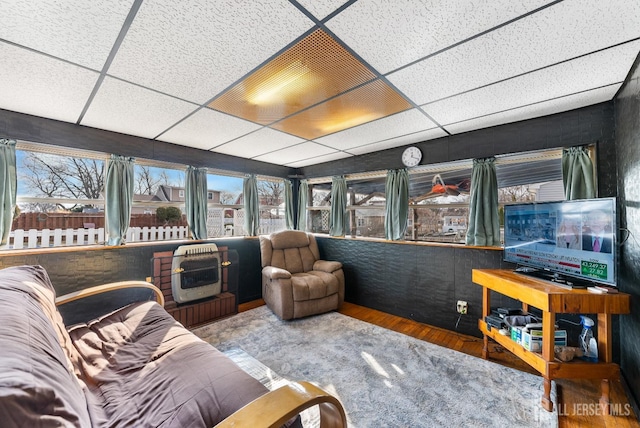 sunroom / solarium with heating unit and a drop ceiling