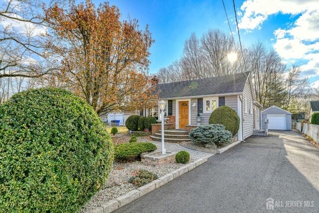 view of front of home featuring a garage and an outdoor structure